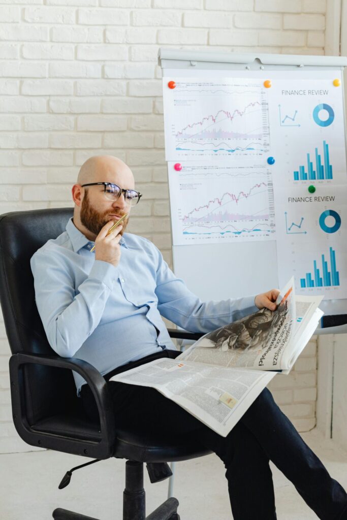 senior management person mulling over news article as related to his company and wondering how to use AI in Strategy Development